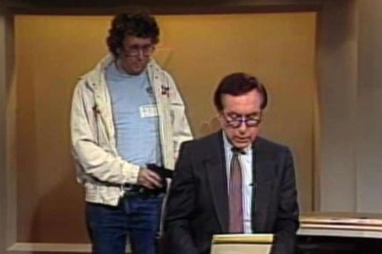 AP19050853667434 This Aug. 20, 1987, image made from video shows an intruder with a gun, as journalist David Horowitz is taken hostage during a live broadcast of Channel 4 Los Angeles. Horowitz remained calm and read the gunman's statements on camera, but the station had