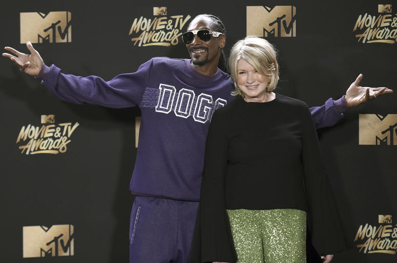 AP19059827021434 In this May 7, 2017 file photo, Snoop Dogg, left, and Martha Stewart pose in the press room at the MTV Movie and TV Awards in Los Angeles. The domestic diva who brought us hemp yarn is now partnering with Canada's Canopy Growth Corp. to develop new produc