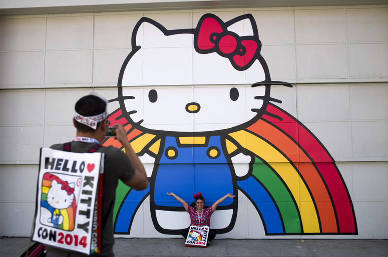 AP19064761589714 In this Oct. 30, 2014, file photo, Keith Nunez, left, takes pictures of his wife, Carolina, at the first-ever Hello Kitty fan convention, Hello Kitty Con, at the Geffen Contemporary at MOCA in Los Angeles. (AP Photo/Jae C. Hong, File)