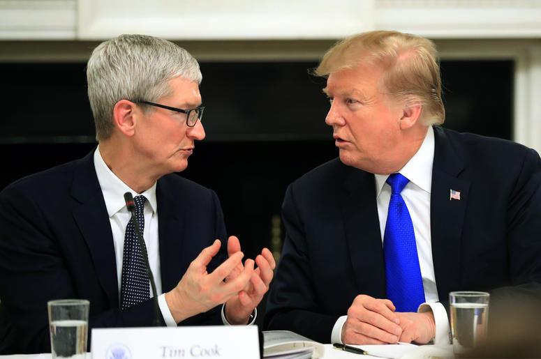 AP19066789722766 In this Wednesday, March 6, 2019 file photo, President Donald Trump talks to Apple Inc. CEO Tim Cook during the American Workforce Policy Advisory Board's first meeting in the State Dining Room of the White House in Washington. (AP Photo/Manuel Balce Cene