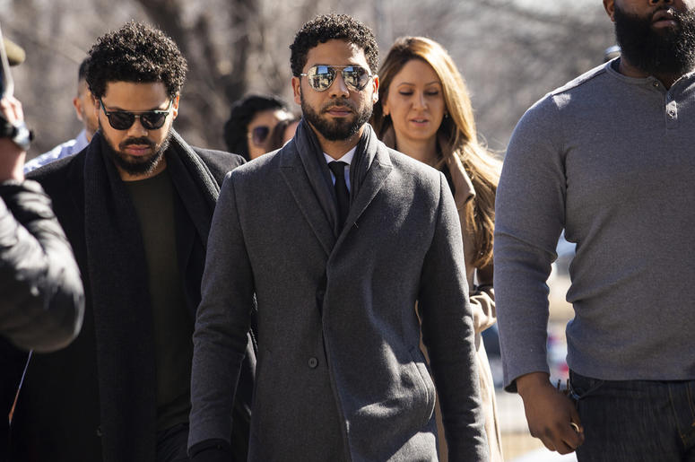 AP19071587816568 "Empire" actor Jussie Smollett, center, arrives at Leighton Criminal Court Building for a hearing to discuss whether cameras will be allowed in the courtroom during his disorderly conduct case on Tuesday, March 12, 2019, in Chicago. (Ashlee Rezin/Chicago