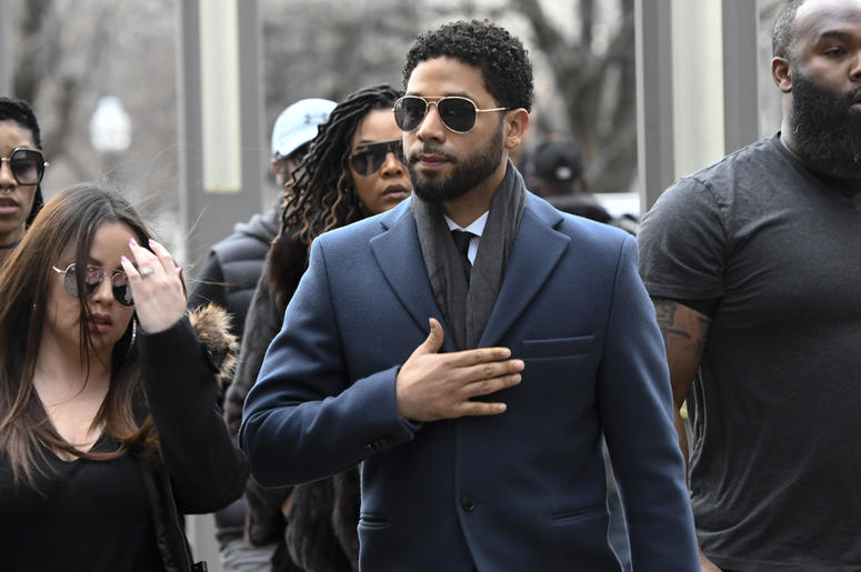 AP19073506924912 'Empire' actor Jussie Smollett, center, arrives at the Leighton Criminal Court Building for his hearing on Thursday, March 14, 2019, in Chicago. (AP Photo/Matt Marton)