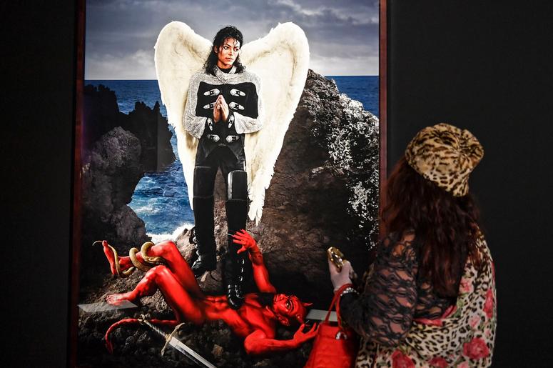 AP19080418671479 A visitor watches the picture 'Archangel Michael: And no message could have been any clearer' from US artist David LaChapelle at a preview of the exhibition 'Michael Jackson: On The Wall' at the Bundeskunsthalle museum in Bonn, Germany, Thursday, March 21