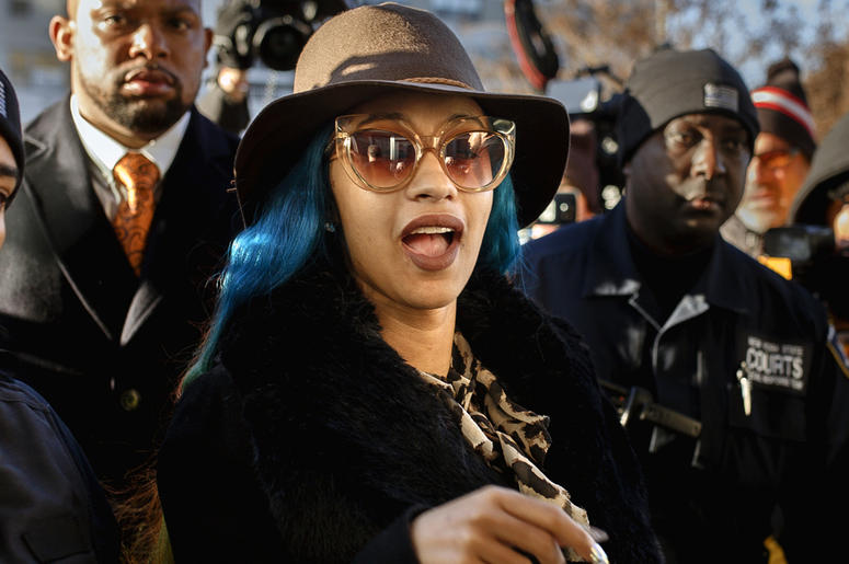AP19085810205763 This Dec. 7, 2018 file photo shows Rapper Cardi B, center, arriving at Queens County Criminal Court in New York on charges related to a brawl at a New York strip club. (AP Photo/Andres Kudacki, File)
