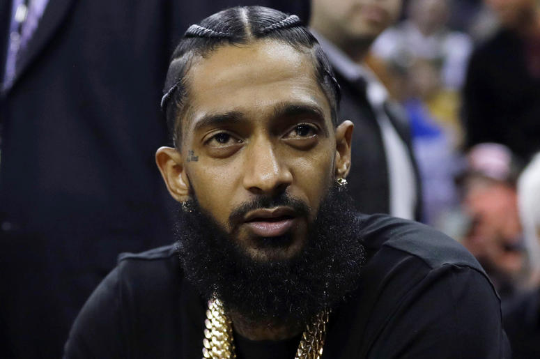 AP19092790586646 This March 29, 2018 file photo shows rapper Nipsey Hussle at an NBA basketball game between the Golden State Warriors and the Milwaukee Bucks in Oakland, Calif. Hussle was shot and killed Sunday, March 31, 2019 outside of his clothing store in Los Angeles