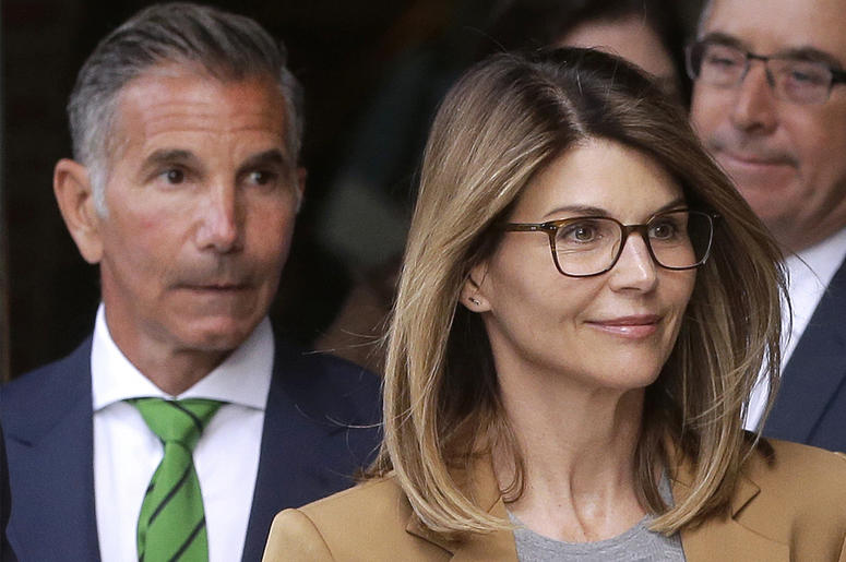 AP19099640965711 In this April 3, 2019 file photo, actress Lori Loughlin, front, and husband, clothing designer Mossimo Giannulli, left, depart federal court in Boston after facing charges in a nationwide college admissions bribery scandal. (AP Photo/Steven Senne, File)