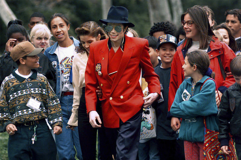 AP19106483295861 In this April 18, 1995, file photo, pop star Michael Jackson and Lisa Marie Presley, behind him at left, walk with children that were invited guests at his Neverland Ranch home in Santa Ynez, California. (Photo credit: AP Photo/Mark J. Terrill, File)