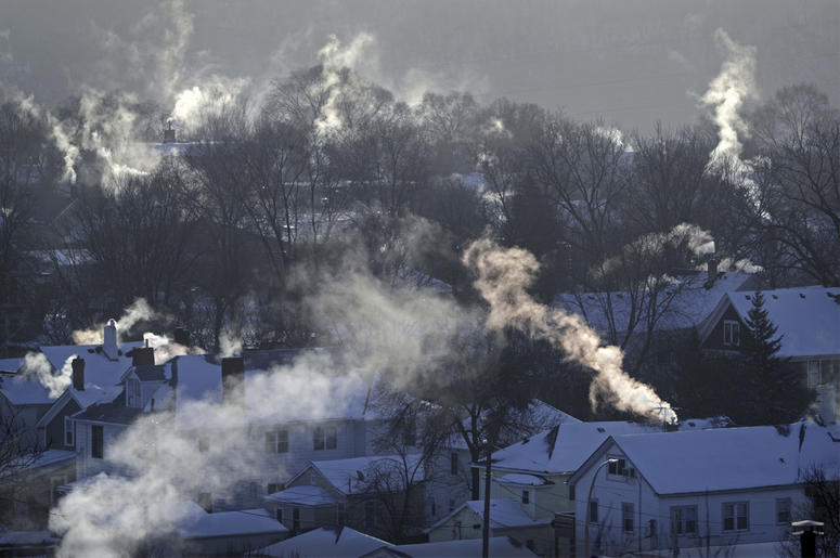 AP19108686034184 In this Wednesday Jan. 30, 2019, file photo smoke rises from the chimneys of homes in St. Paul, Minnesota (Brian Peterson/Star Tribune via AP, File)