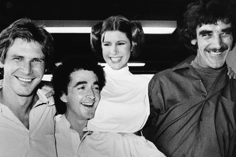 AP19122819079602 In this Oct. 5, 1978 file photo, actors featured in the "Star Wars" movie, from left, Harrison Ford who played Han Solo, Anthony Daniels who played the robot C3P0, Carrie Fisher who played the princess, and Peter Mayhew who played the Wookie, Chewbacca, a