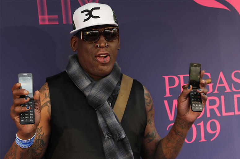 AP19132007715548 In this Jan. 26, 2019, file photo, Dennis Rodman poses with two flip phones on the blue carpet at the Pegasus World Cup Invitational Horse Race at Gulfstream Park in Hallandale Beach, Fla. (AP Photo/Lynne Sladky, File)