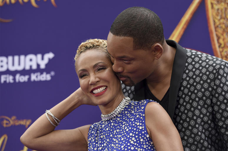 AP19191495386089 In this May 21, 2019 file photo, Will Smith, right, kisses Jada Pinkett Smith as they arrive at the premiere of "Aladdin" at the El Capitan Theatre in Los Angeles. (Photo by Chris Pizzello/Invision/AP, File)