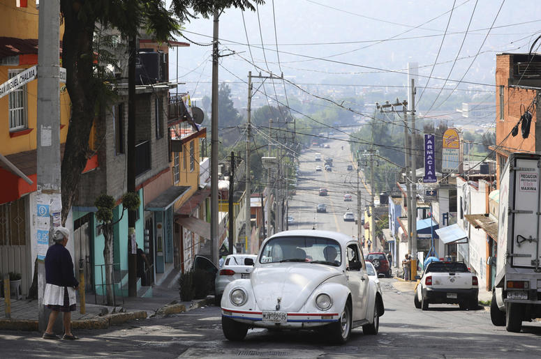 AP19191733162363 A Volkswagen Beetle makes it to the top of a hill in a neighborhood of Mexico City known colloquially as "Vocholandia," for its love of the classic Beetle, called vochos, Tuesday, July 9, 2019. (AP Photo/Cristina Baussan)