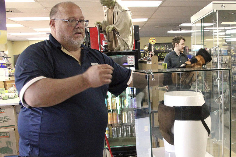 AP18199657978131 In this May 2, 2018 file photo, Blockbuster Alaska general manager Kevin Daymude moves a display case featuring the jockstrap worn by actor Russell Crowe in the 2005 movie "Cinderella Man" at a Blockbuster video store in Anchorage, Alaska. Everything in t