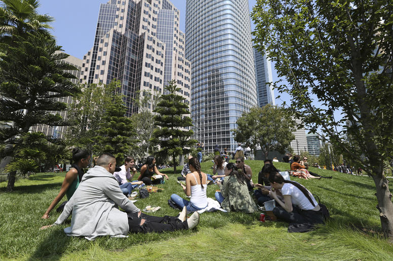AP18227859076764 In this photo taken Wednesday, Aug. 15, 2018, employees from marketing company Linqia have a picnic lunch on the rooftop park of the new Transbay Transit Center in San Francisco. The new $2.2 billion center opened earlier this month. (AP Photo/Lorin Eleni
