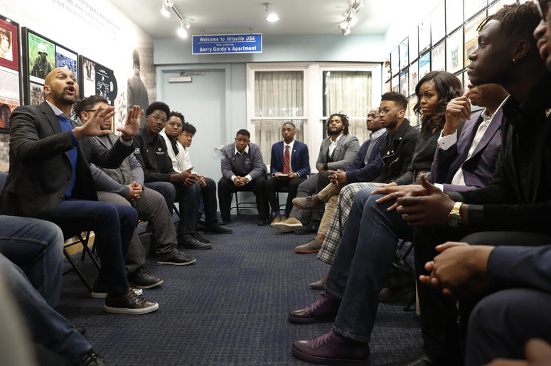 AP18345755041931 Actor Keegan-Michael Key, left, speaks while former First Lady Michelle Obama, right, listens with Wayne State University students at the Motown Museum in Detroit, Tuesday, Dec. 11, 2018. (AP Photo/Paul Sancya)