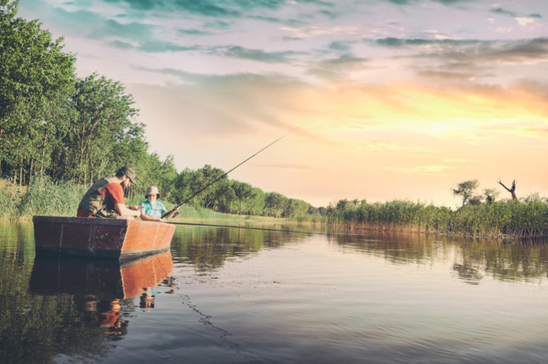 Father and Son Fishing in a Boat Father and Son Fishing in a Boat