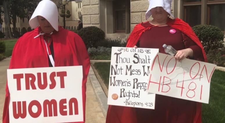Dressed as characters from the fictional tv show and book "The Handmaids Tail" (about a totalitarian society) protestors have been assembling at the GA Capitol Dressed as characters from the fictional tv show and book "The Handmaids Tail" (about a totalitarian society) protestors have been assembling at the GA Capitol