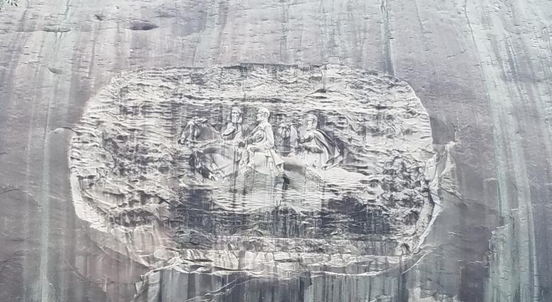 The Confederate memorial carving at Stone Mountain includes 3 central figures from the Civil War