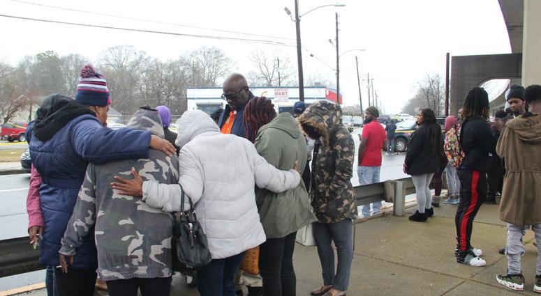 A circle of prayer is held across from the auto sales business where the bodies of 2 men were found inside a vehicle Thursday morning A circle of prayer is held across from the auto sales business where the bodies of 2 men were found inside a vehicle Thursday morning