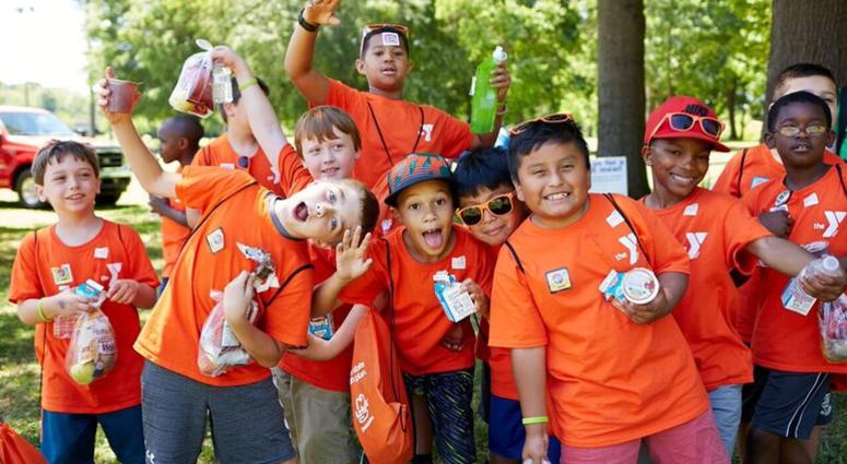 Children are seen participating in a summer meals program