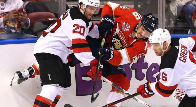 Apr 6, 2019; Sunrise, FL, USA; Florida Panthers center Aleksander Barkov (16) passes the puck as New Jersey Devils center Blake Coleman (20) and defenseman Andy Greene (6) defend in the first period at BB&T Center. Florida Panthers NHL Playoffs