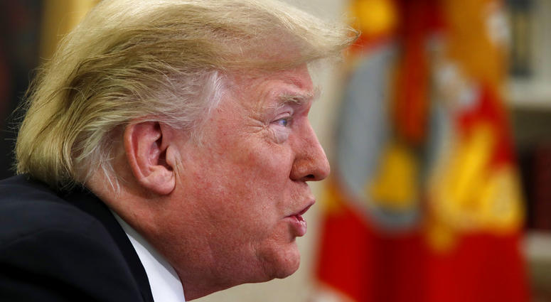 President Donald Trump speaks to members of the five branches of the military by video conference on Christmas Day, Tuesday, Dec. 25, 2018, in the Oval Office of the White House.
