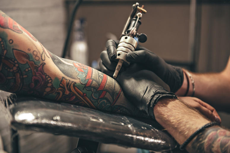 Person getting tattooed Person getting tattooed