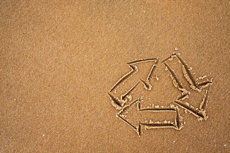 Recycle symbol on beach