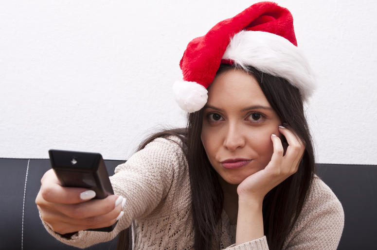woman in santa hat with remote