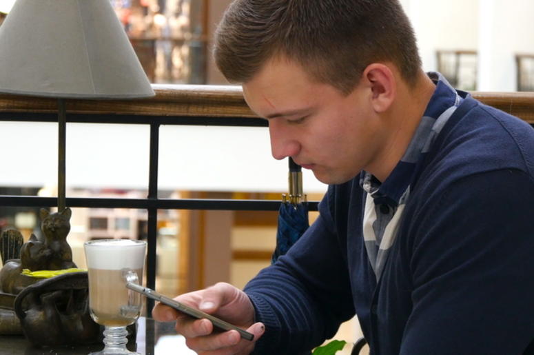 Man Scrolling Through Phone Man Scrolling Through Phone