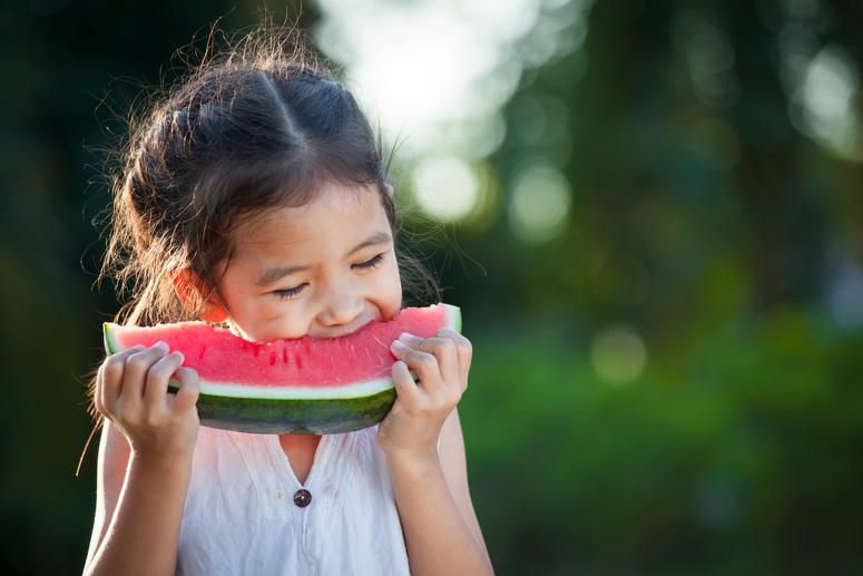 Little girl eating a watermelon. Little girl eating a watermelon.