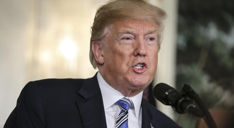 President Donald Trump speaks about the spending bill during a press conference in the Diplomatic Reception Room at the White House on March 23, 2018. Donald Trump