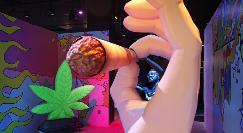 In this Tuesday, Sept. 18, 2018 photo, Gabe Williams works on a exhibit at the Cannabition cannabis museum in Las Vegas.