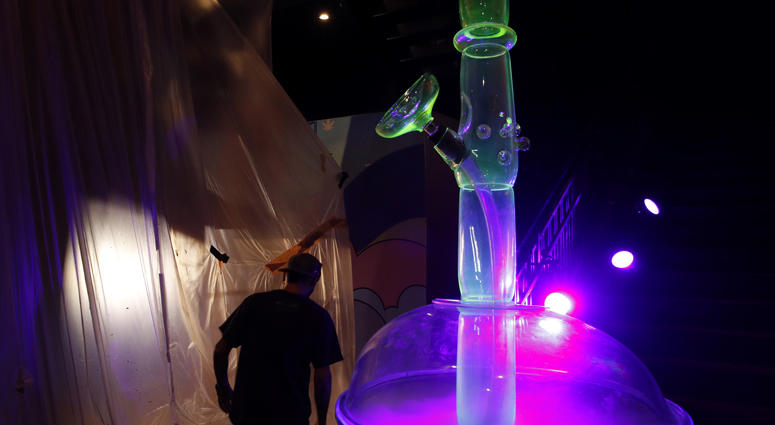In this Tuesday, Sept. 18, 2018 photo, a man walks by a 24-foot-tall bong at the Cannabition cannabis museum in Las Vegas
