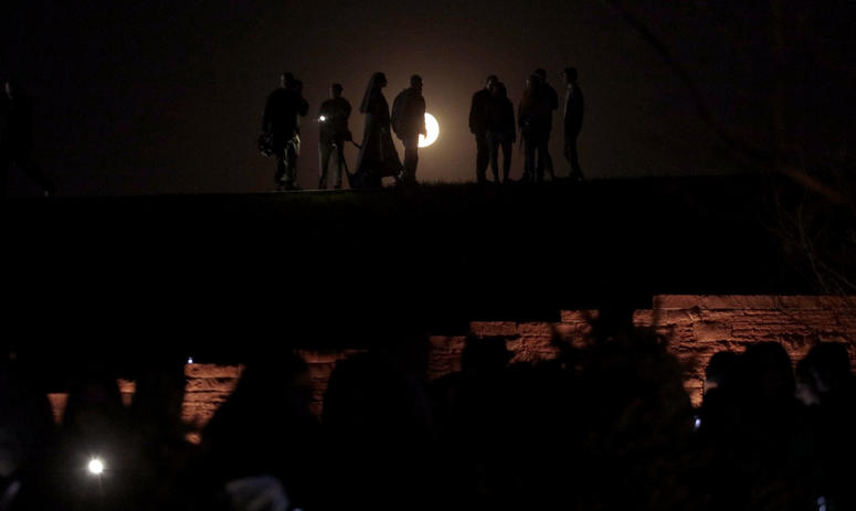 The moon rises over the Columbine Memorial during a candle light vigil on April 19, 2019 in Littleton, Colorado. Columbine anniversary