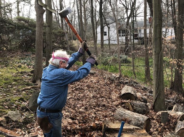 Bob Borsody splitting wood in a backyard in Westchester County. Bob Borsody