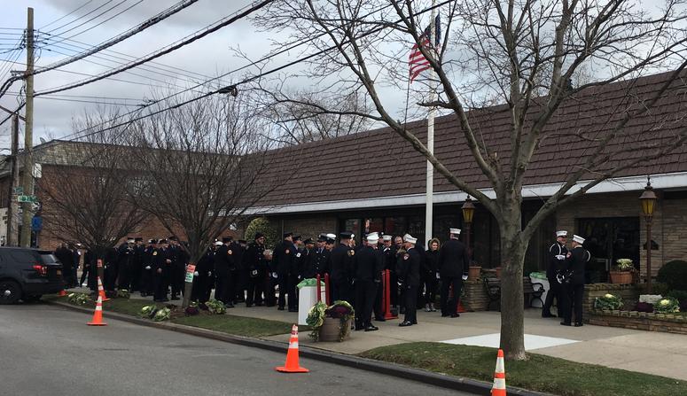 A line of people waits to enter the wake for Steven Pollard. Steven Pollard Wake
