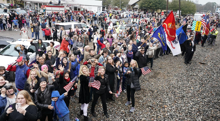People pay their respects as the train carrying the casket of former President George H.W. Bush passes Thursday, Dec. 6, 2018, along the route from Spring to College Station, Texas. President George H.W. Bush Final Train Ride