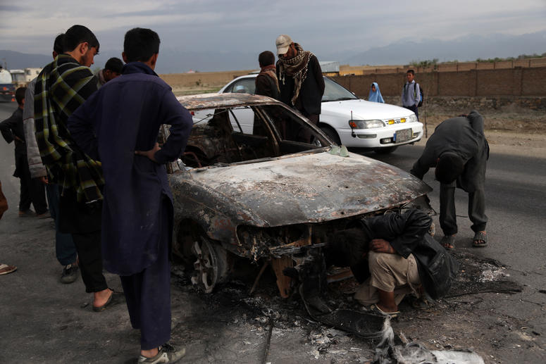 People gather at the site of an attack near the Bagram Air Base in Parwan province, Afghanistan, April 9, 2019. Afghanistan bombing