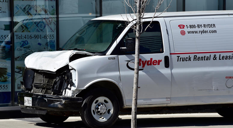 A van with a damaged front-end sits idle on a sidewalk after the driver drove down a sidewalk crashing into a number of pedestrians in Toronto, Monday, April 23, 2018. Toronto Van Attack