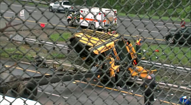 This image taken from WABC-TV video shows an overturned school bus after it collided with a dump truck, injuring multiple people, on Interstate 80 in Mount Olive, N.J., Thursday, May 17, 2018. Deadly New Jersey School Bus Crash