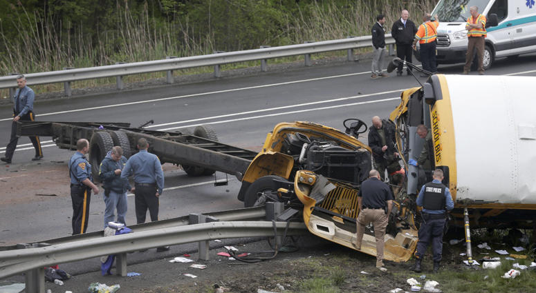 Emergency personnel work at the scene of a school bus and dump truck collision, injuring multiple people, on Interstate 80 in Mount Olive, N.J., Thursday, May 17, 2018. Deadly New Jersey School Bus Crash