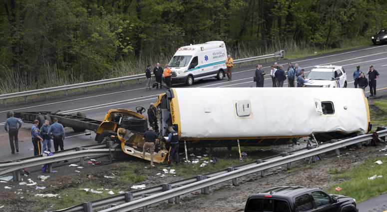 Emergency personnel examine a school bus after it collided with a dump truck, injuring multiple people, on Interstate 80 in Mount Olive, N.J., Thursday, May 17, 2018. Deadly New Jersey School Bus Crash
