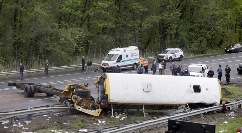 Emergency personnel work at the scene of a school bus and dump truck collision, injuring multiple people, on Interstate 80 in Mount Olive, N.J., Thursday, May 17, 2018. Deadly New Jersey School Bus Crash