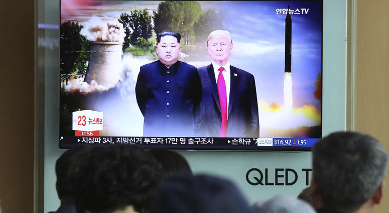 People watch a TV screen showing file footage of U.S. President Donald Trump, right, and North Korean leader Kim Jong Un during a news program at Seoul Railway Station in Seoul, South Korea, Monday, June 11, 2018. Trump-Kim