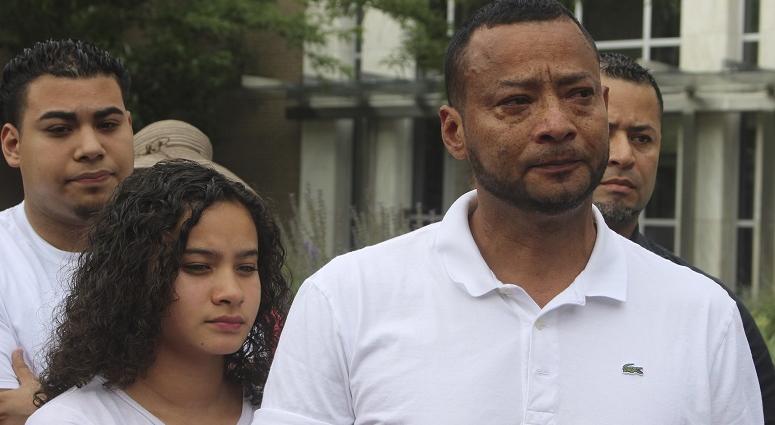 Nelson Rosales Santos, 49, an immigrant who lives in Stamford, Conn., stands next to his 14-year-old daughter, Samantha, at rally outside the federal bridling in Hartford, Conn., on Thursday, June 14, 2018. Nelson Rosales Santos