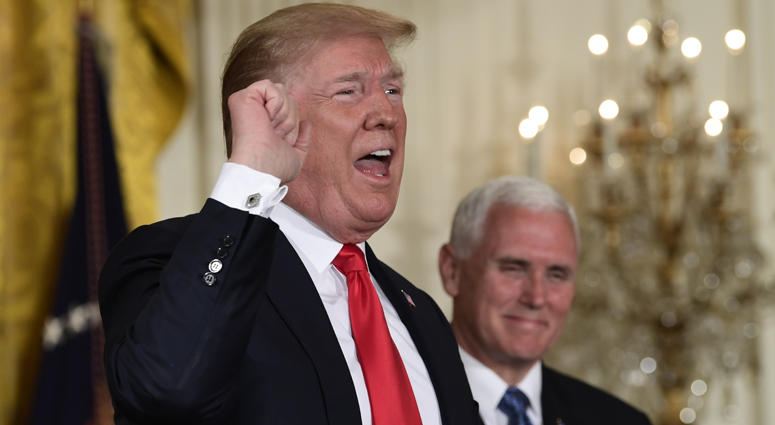President Donald Trump speaks at the beginning of a National Space Council meeting in the East Room of the White House in Washington, Monday, June 18, 2018, as Vice President Mike Pence looks on. Donald Trump