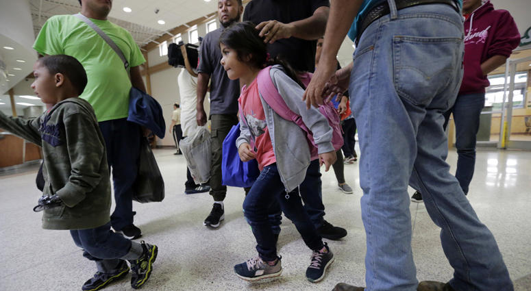 A group of immigrants from Honduras and Guatemala seeking asylum arrive at the bus station after they were processed and released by U.S. Customs and Border Protection, Thursday, June 21, 2018, in McAllen, Texas. Migrant Children