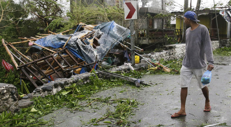A man looks at a damaged house due to strong winds from Typhoon Mangkhut as it barreled across Tuguegarao city in Cagayan province Typhoon Mangkhut