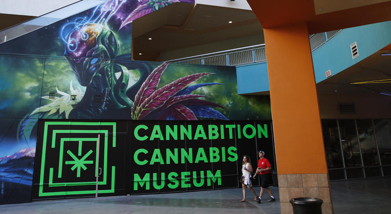 In this Tuesday, Sept. 18, 2018 photo, people walk by the Cannabition cannabis museum in Las Vegas.